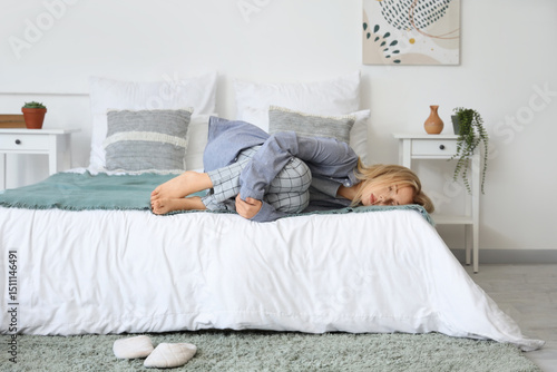 Depressed young woman lying...