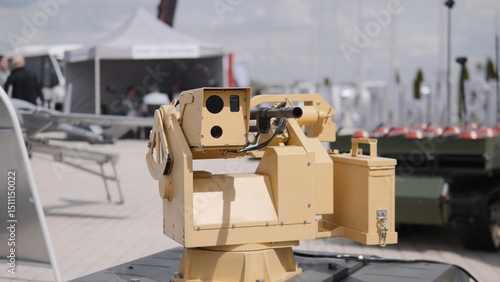 A remote-controlled weapon system is prominently showcased at a military technology expo, highlighting advancements in defense and robotic warfare technology.