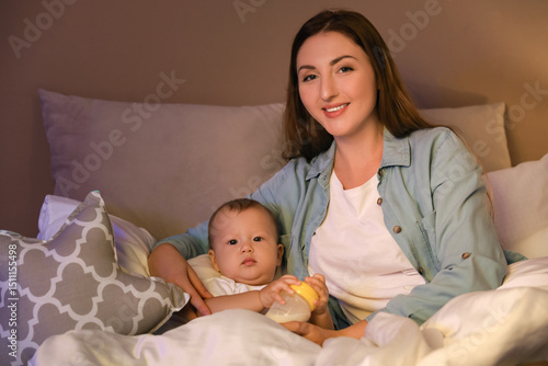 Mother with bottle of milk ...