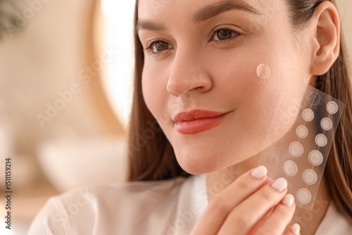 Canvastavla Young woman with pimple patches in bathroom, closeup