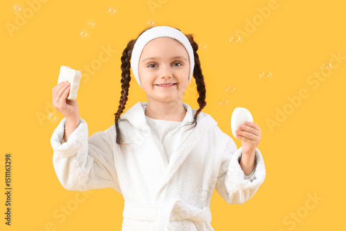 Little girl in bathrobe wit...