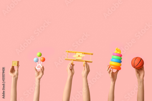 Hands holding baby toys on ...