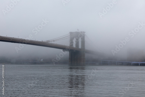 View of Brooklyn Bridge as fog covers the city