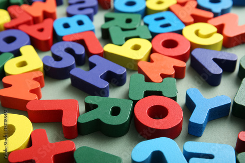 Bilde på lerret Colorful English letters on green background, closeup