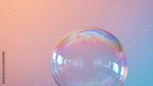 A soap bubble floating against a pastel gradient backdrop. 