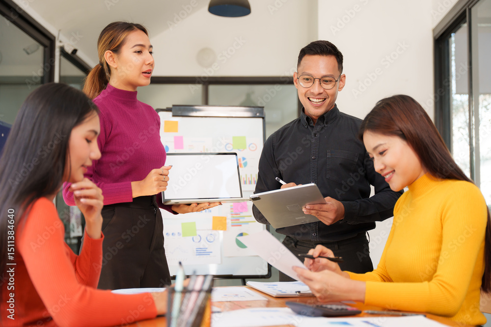 Group of Asian business people working together in an office Group of Asian business people working together in an office