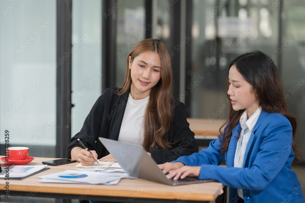 Two young female businesswomen are meeting in an office. Two young female businesswomen are meeting in an office.