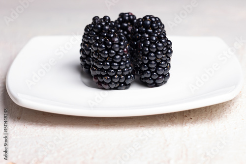 Minimalist Close-Up of Fresh Blackberries on White Plate