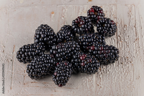 Fresh Ripe Blackberries on rustic light wooden background - macro close-up