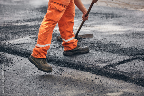 Wallpaper Mural Construction worker working on a new asphalt layer on a public street. Torontodigital.ca