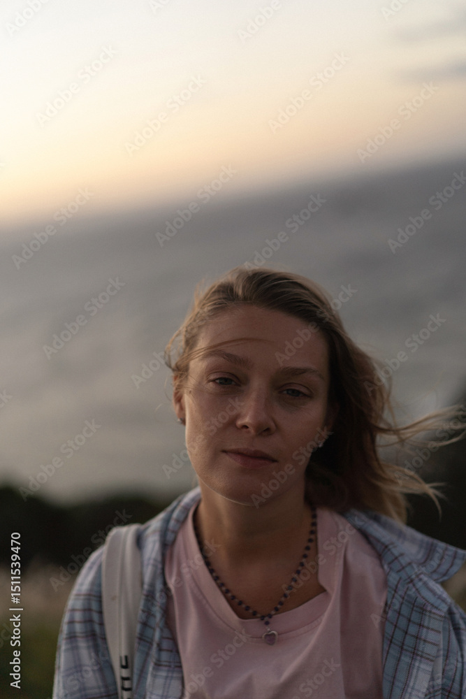 Woman traveller watching sunset at lighthouse at Cape Byron Lighthouse Woman traveller watching sunset at lighthouse at Cape Byron Lighthouse