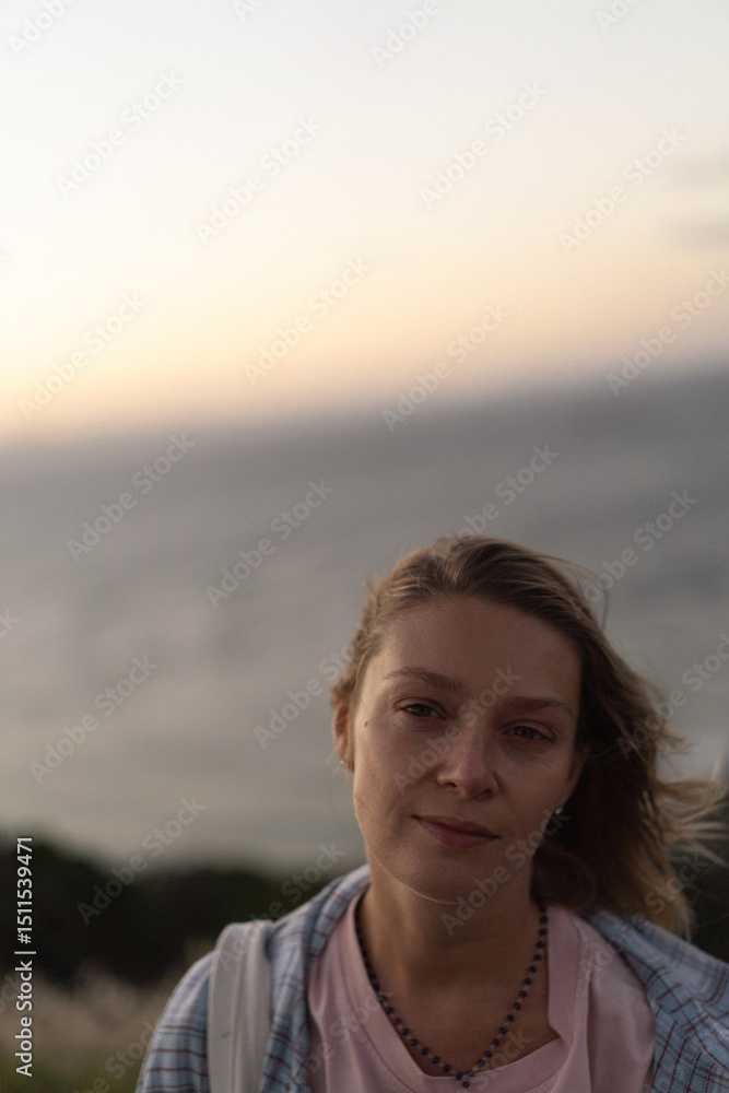 Woman traveller watching sunset at lighthouse at Cape Byron Lighthouse Woman traveller watching sunset at lighthouse at Cape Byron Lighthouse