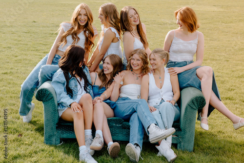 Eight sorority sisters smiling and relaxing on sofa outdoors