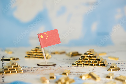 Photography Chinese flag stands prominently on world map, surrounded by gleaming gold bars,