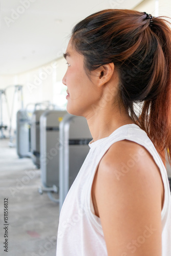 Free Download Vertical, Side profile of Asian woman standing inside gym. - GFXLoad