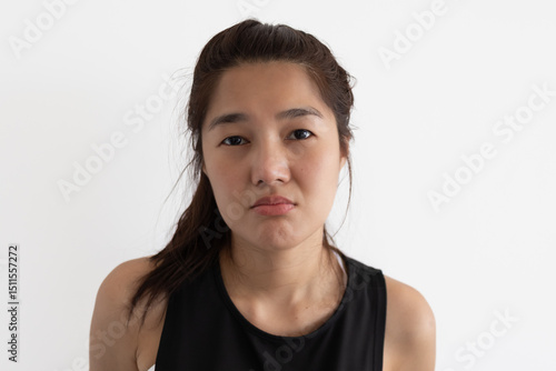 Photography Asian woman pouting while staring directly at camera, isolated over white background wall