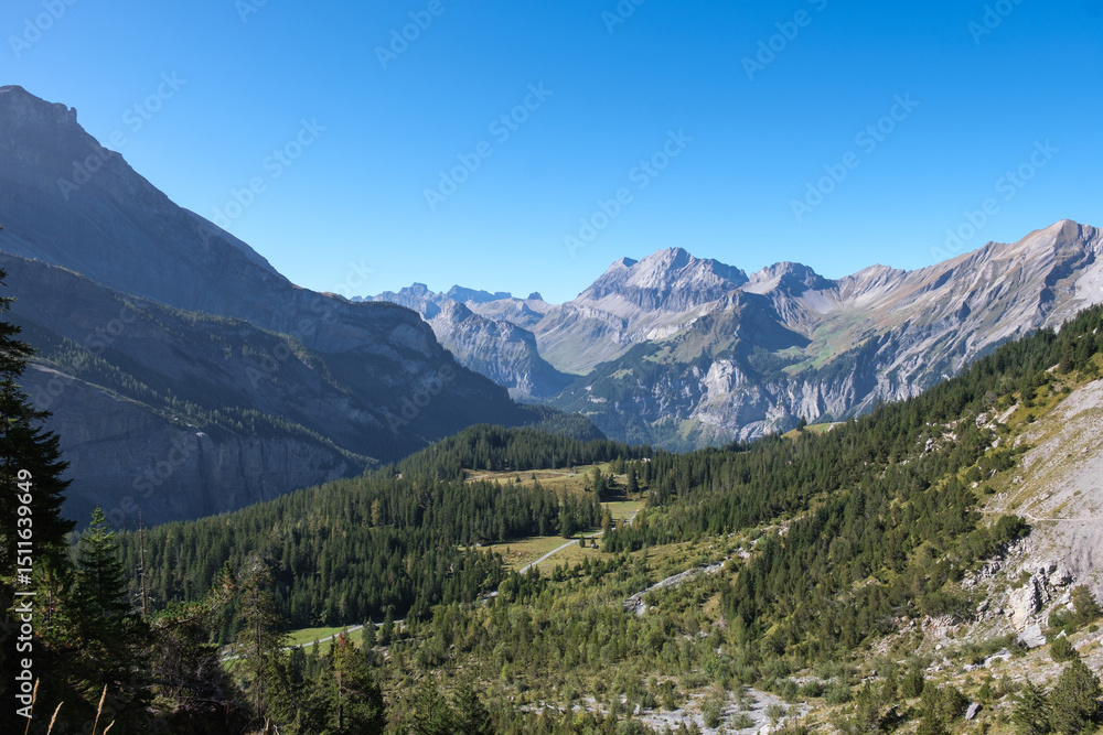 Mountain landscape in the Swiss Alps in the region of Kandersteg and Oeschinen Lake with a beautiful weather and a blue sky Mountain landscape in the Swiss Alps in the region of Kandersteg and Oeschinen Lake with a beautiful weather and a blue sky