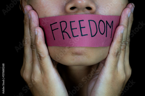 Billede på lærred Silenced Womans mouth taped with FREEDOM message on dark background
