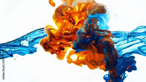 Colorful orange and blue paint drops dynamically mix and swirl together on white background creating mesmerizing abstract fluid art patterns with organic flowing movements
