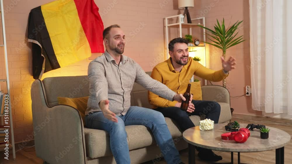 Friends cheer together while watching sports in cozy living room Friends cheer together while watching sports in cozy living room