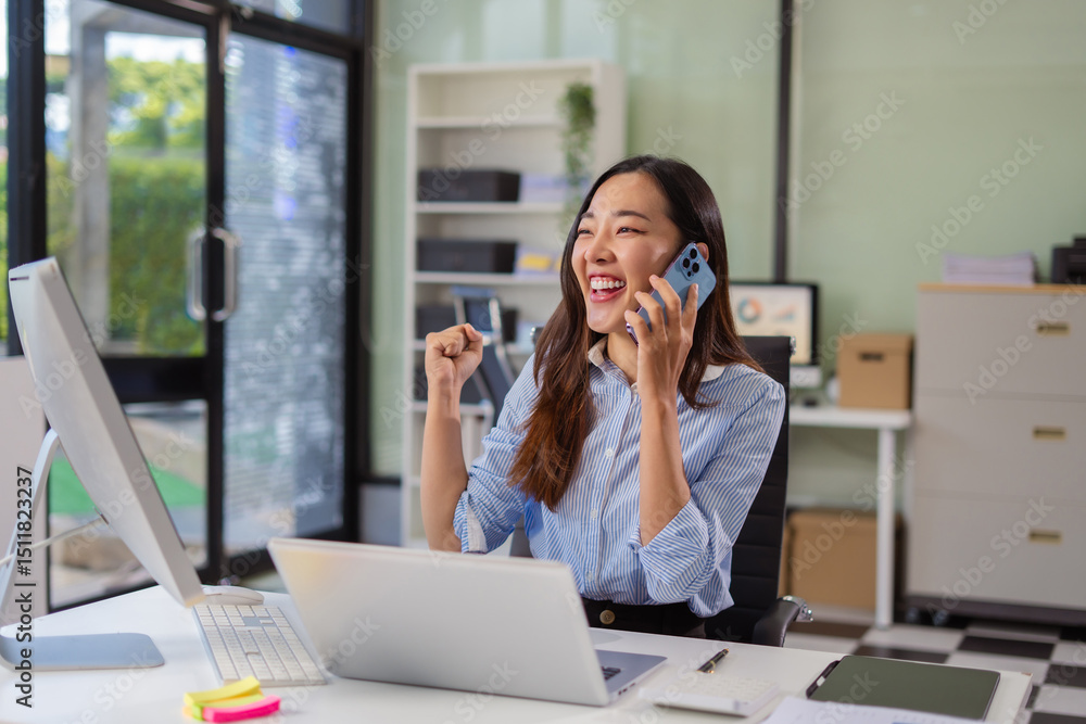 Overjoyed charming excited woman business woman worker using smartphone and laptop working in office, feeling happy.. Overjoyed charming excited woman business woman worker using smartphone and laptop working in office, feeling happy..