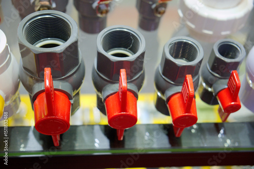 Showcasing various sizes of plumbing valves that feature bright red handles for easy and efficient operation