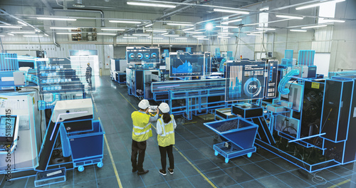 Two Engineers in Safety Vests Use a Tablet to Interact With Holographic Data in a High-tech Factory, Activate AI Facility Analysis, Advanced Machinery, Digital Interfaces, Futuristic Manufacturing