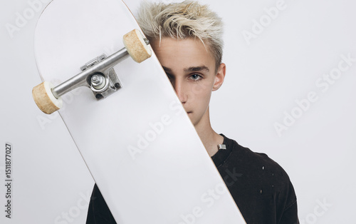 Skate & Style: Teen Energy with Urban Vibes. Teen Boy with Skateboard Posing in Studio on White Background