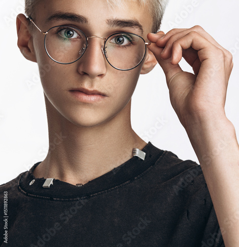 Stylish Teenage Boy Wearing Glasses Looking at Camera on White Background