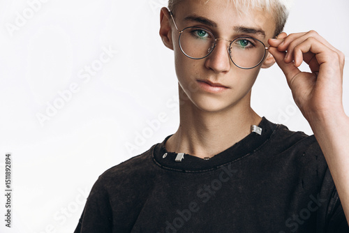Stylish Teenage Boy Wearing Glasses Looking at Camera on White Background