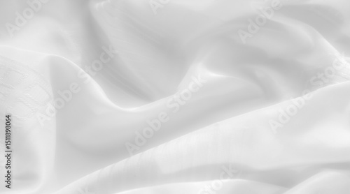 white fabric with a subtle pattern delicately captured in the folds. The fabric reflects light, creating a smooth, satiny appearance. Its texture appears silky,