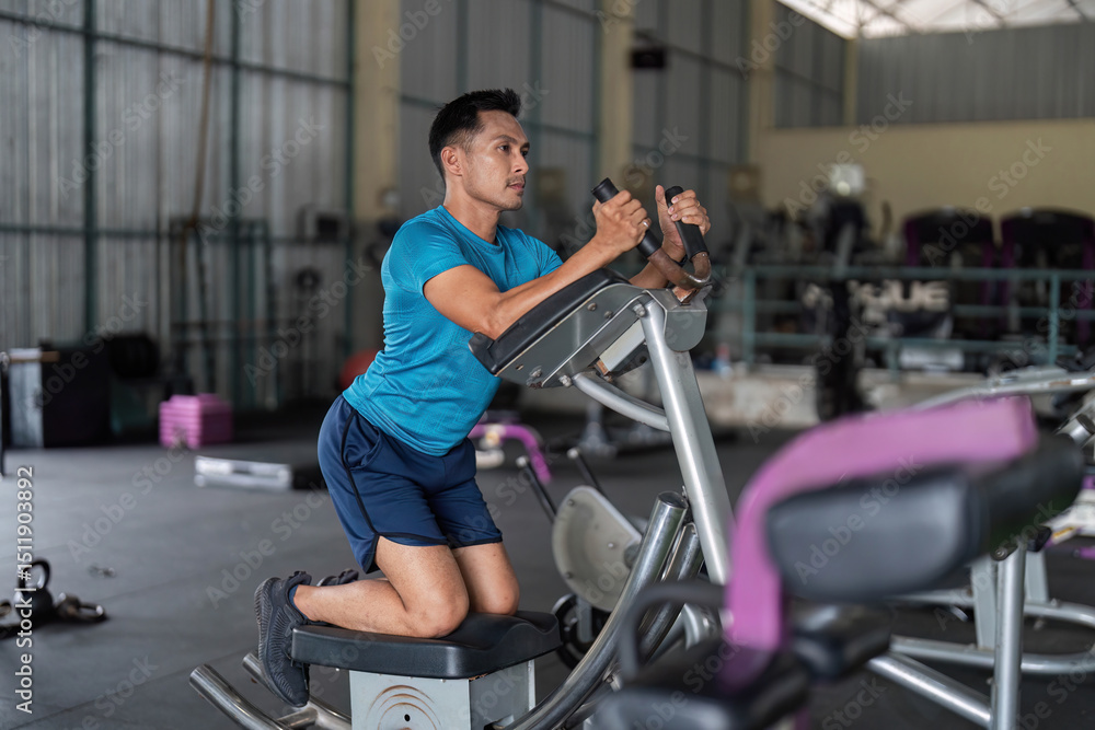 Fitness Enthusiast. Man performing workout on elliptical machine. Fitness Enthusiast. Man performing workout on elliptical machine.