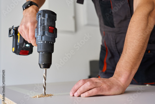Wallpaper Mural Male hands drilling wooden board with power drill. Process of carpentry working in home workshop, drills hole in chipboard Torontodigital.ca