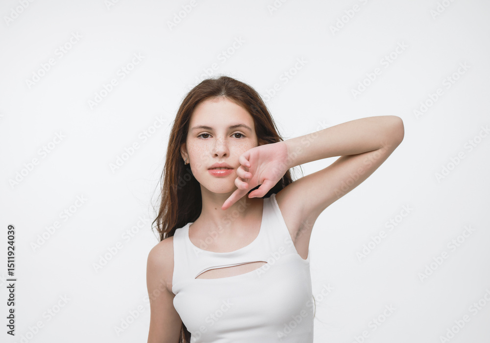 A brunette girl in a white tank top on a white background., A brunette girl in a white tank top on a white background.,
