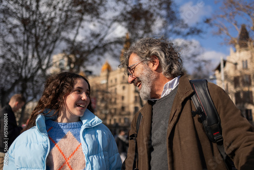 Photography Happy grandfather and granddaughter walking and talking in barcelona city center