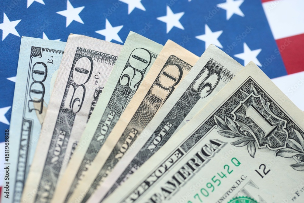 American US dollars money bills and on American flag close up American US dollars money bills and on American flag close up