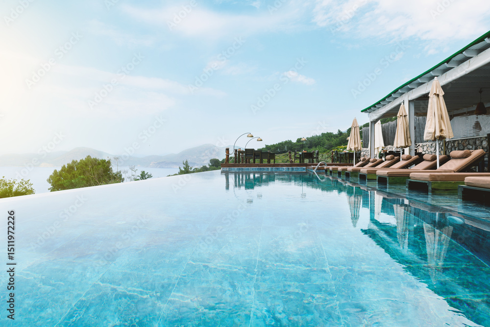 Obraz premium Hotel Infinity Pool and Sun Loungers in Summer
