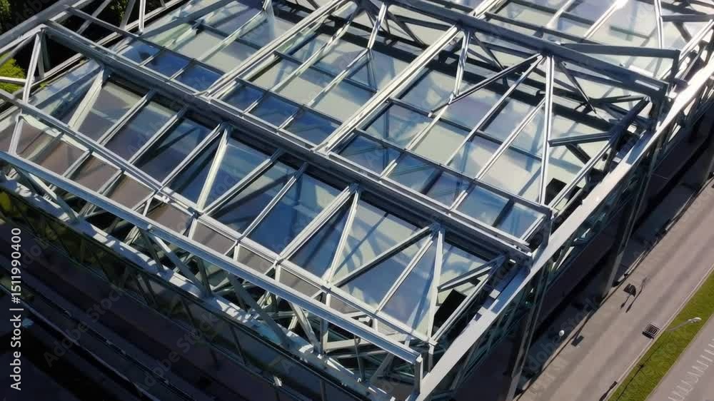 Sleek modern architecture with glass roof structure, geometric steel beams, and natural daylight reflection, featuring steel Sleek modern architecture with glass roof structure, geometric steel beams, and natural daylight reflection, featuring steel