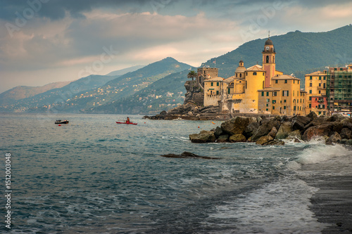 coast with turquoise waves Mediterranean sea and colorful houses with tower o...