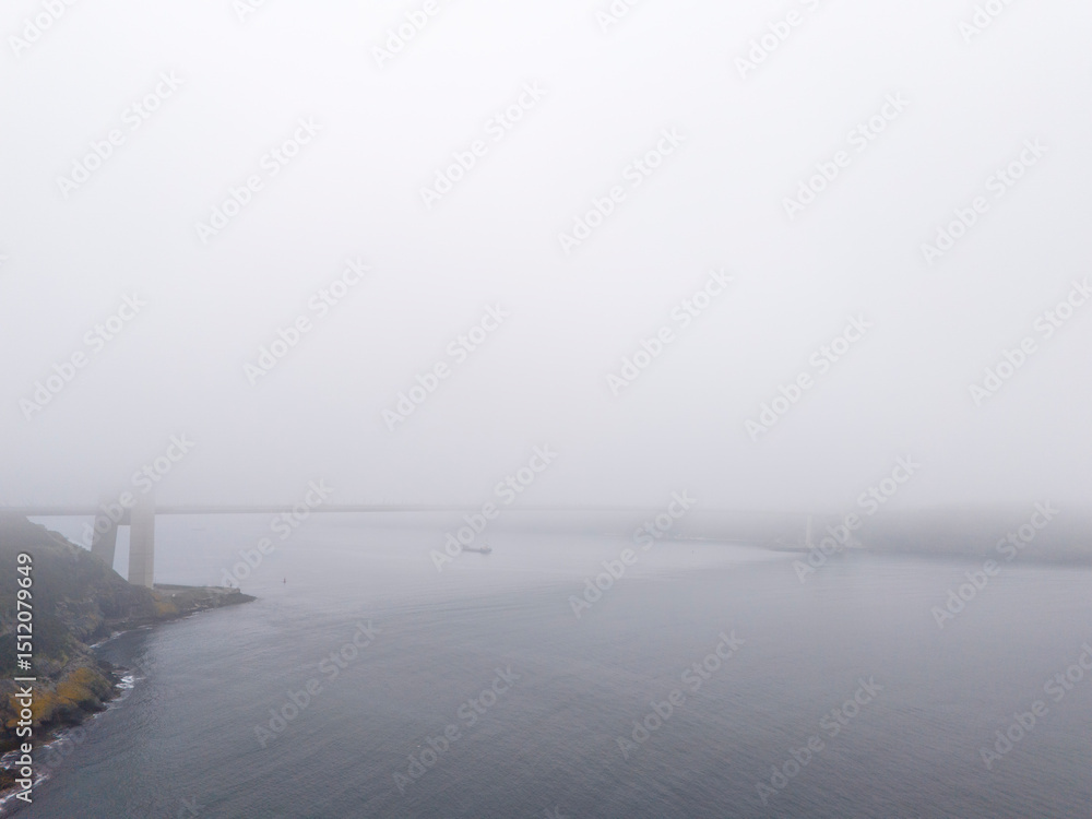 Fototapeta premium Misty River View with Bridge. An aerial view of a river shrouded in fog or mist. Yavuz Sultan Selim Bridge Istanbul Turkey Turkiye Beykoz Poyrazkoy Turkey Turkiye Anatolian Side