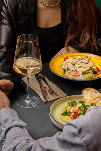 Couple enjoying romantic dinner with wine and gourmet food