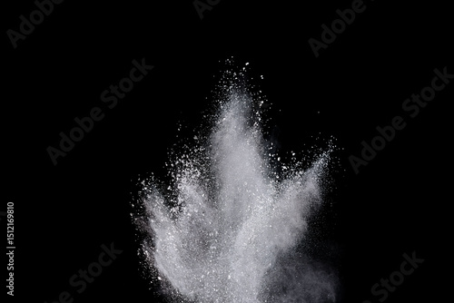 White powder or flour explosion isolated on black background.