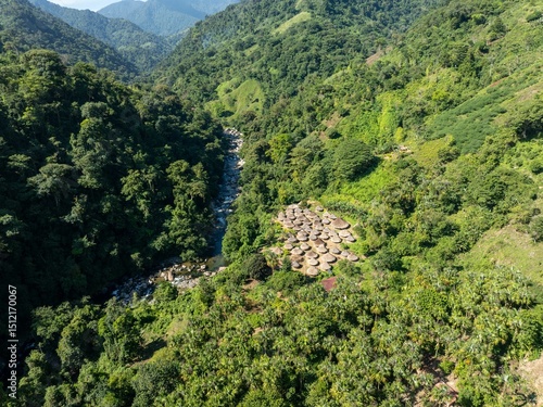 Cabins, village, and huts of the Tayrona and Kogui indigenous people in the Sierra Nevada de Santa Marta in the Colombian jungle. Aerial and panoramic view