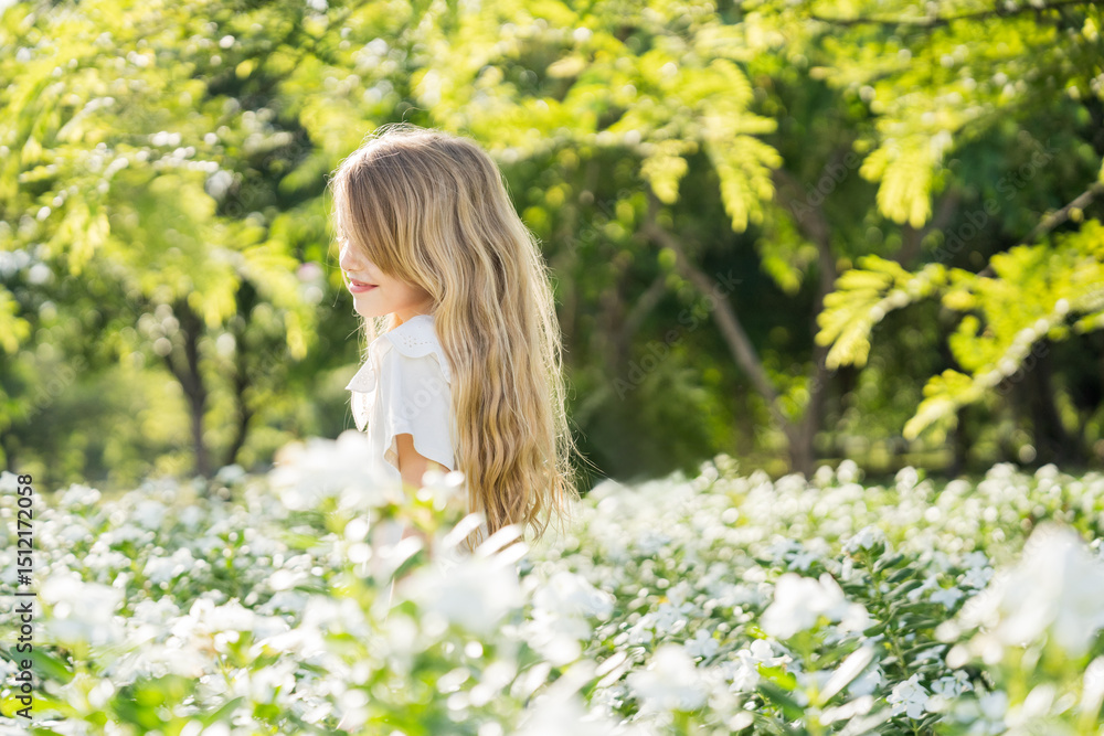 Little girl playing in the garden with morning sunrise Little girl playing in the garden with morning sunrise