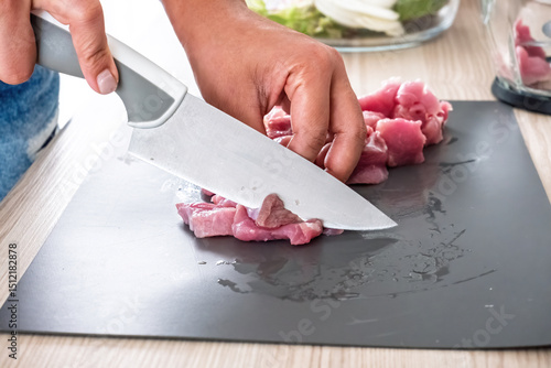 Billede på lærred Chef Slicing Raw Protein on Cutting Board for Healthy Home Meal Preparation