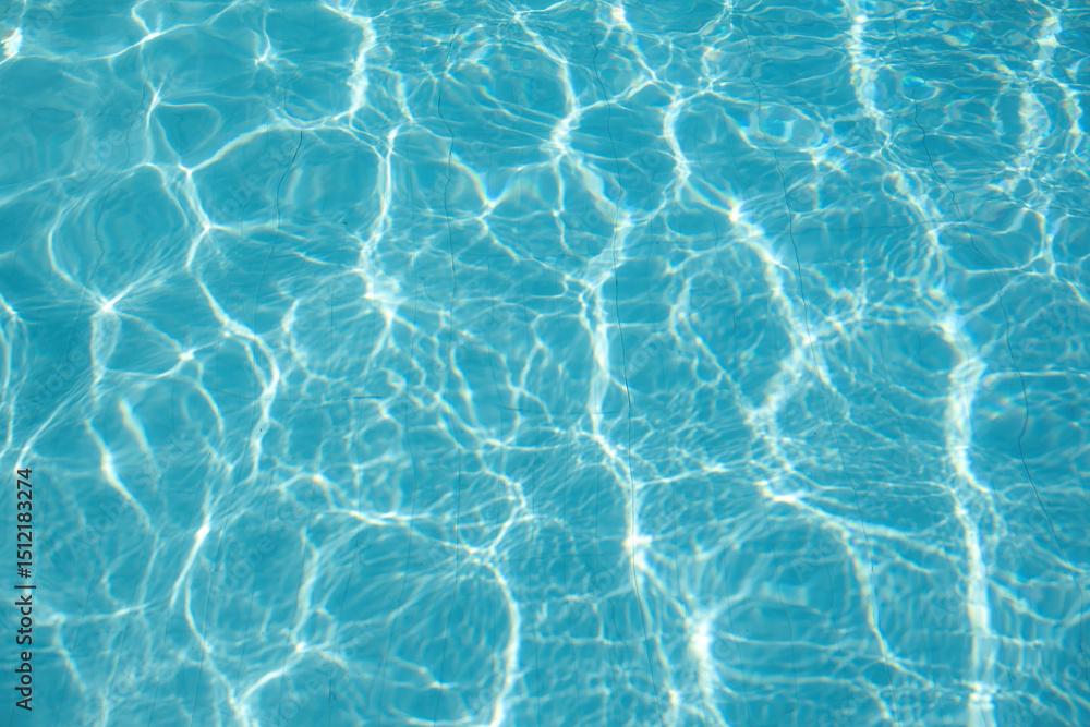 Bright blue swimming pool water with shimmering sunlight reflections, Summer background. Bright blue swimming pool water with shimmering sunlight reflections, Summer background.