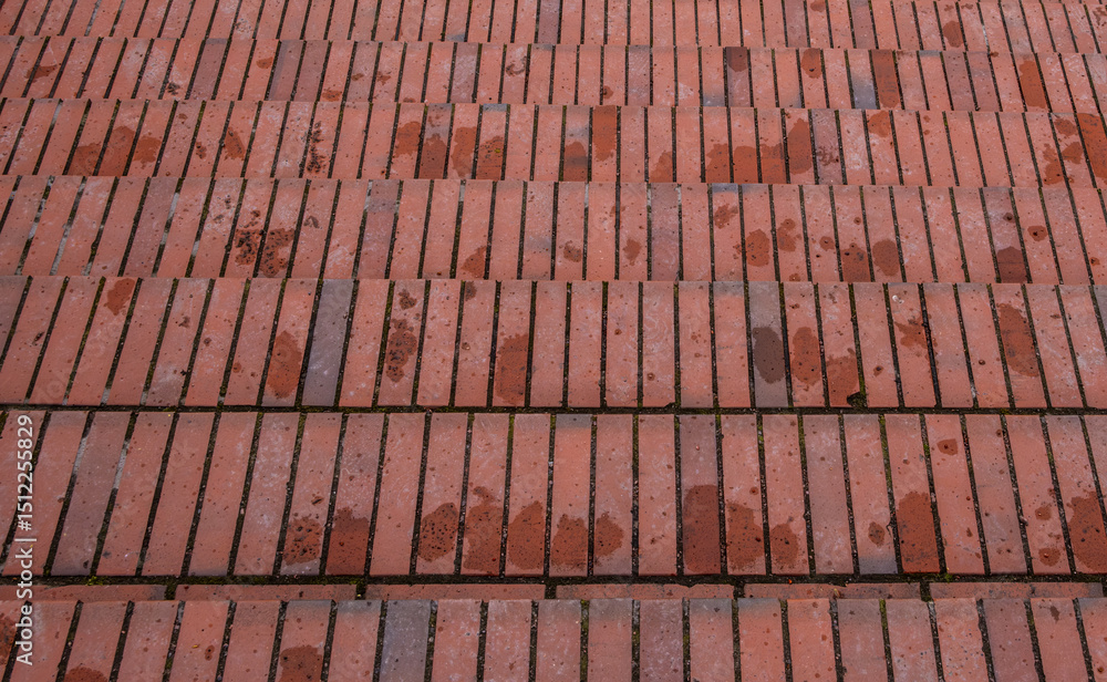 Naklejka premium The staircase is made of red brick after the rain.