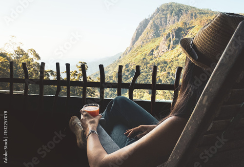 Tableau sur toile Woman sit in chair drink fresh mango juice in balcony viewpoint by breathtaking Ella Rock landmark panorama in Sri Lanka
