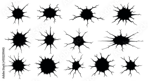 Set of twelve black bullet hole silhouettes with radial cracks
