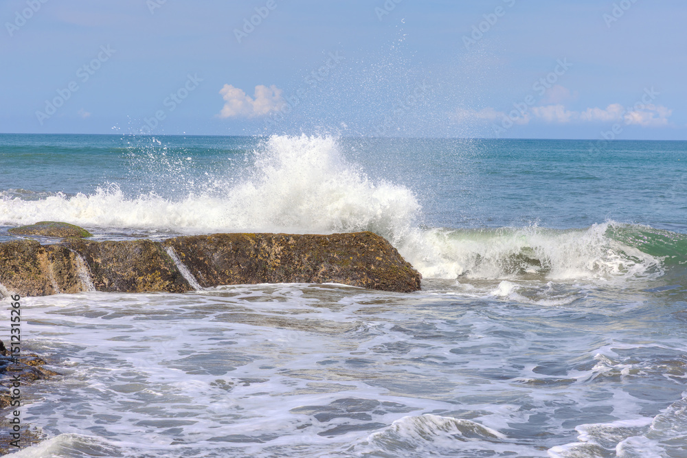 Fototapeta premium Tanah Lot Temple on the island of Bali known as the island of Gods. Sitting on top of rock island over looking turquoise blue beaches in Bali Indonesia
